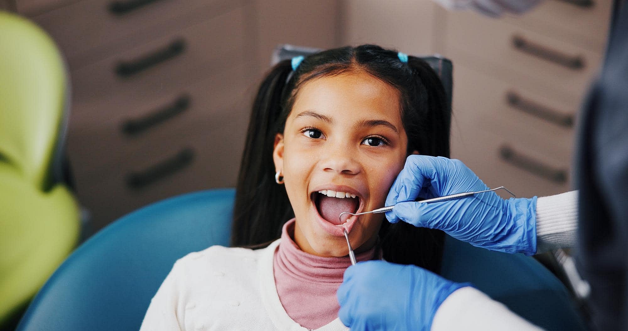 A young girl has her teeth examined by a children’s orthodontist at BeSpoke Orthodontics in Burtonsville, MD.