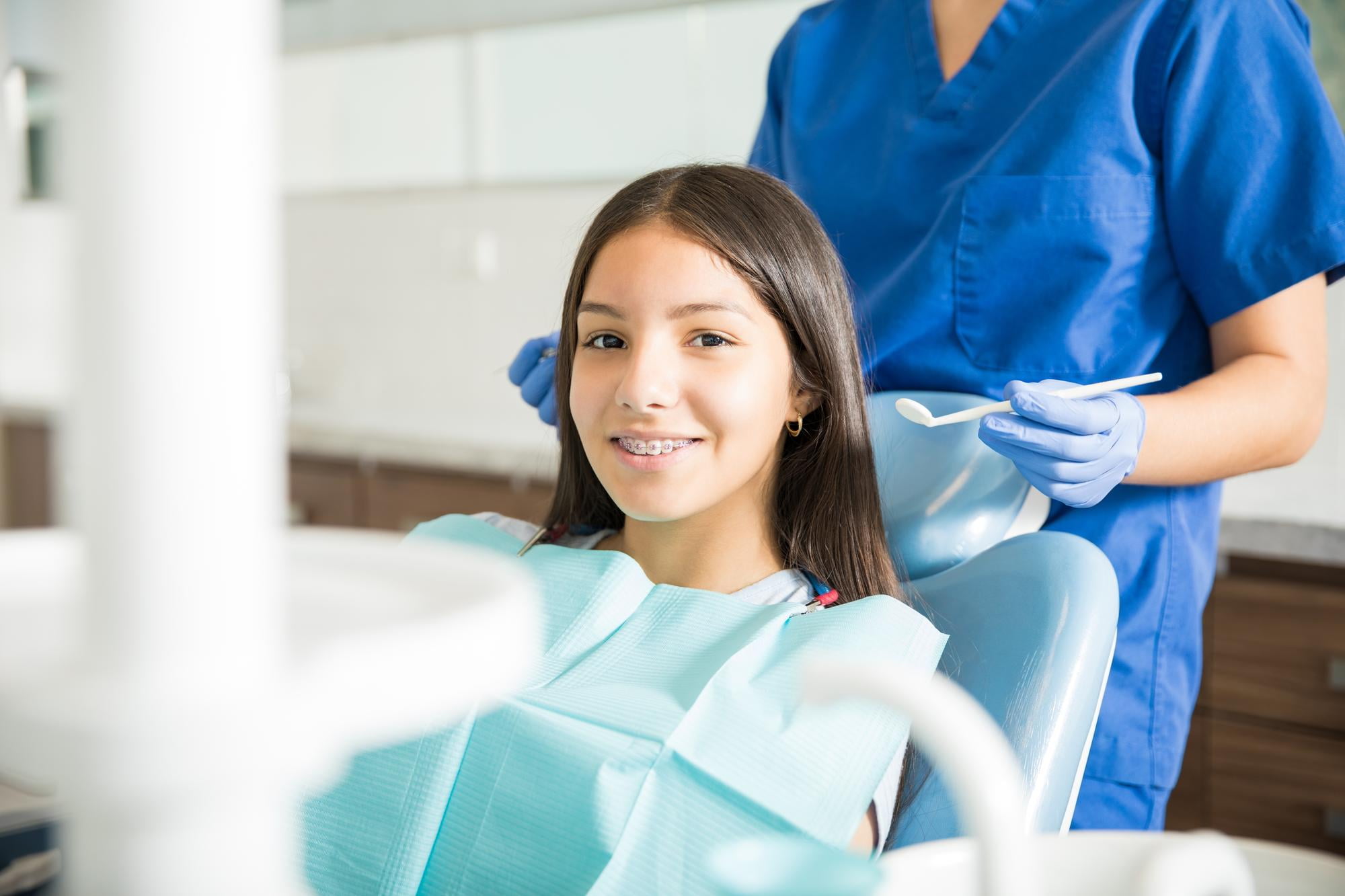 All PPO Insurance Plans Accepted: Orthodontist with Payment Plans Near You At BeSpoke Orthodontics in Burtonsville, MD, a girl with braces consults with a dental professional about insurance costs.