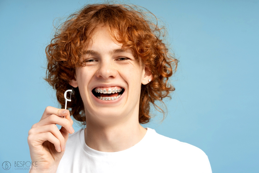 closeup image smiling teenager curly red hair metal braces - How To Floss With Braces in Burtonsville, MD 
