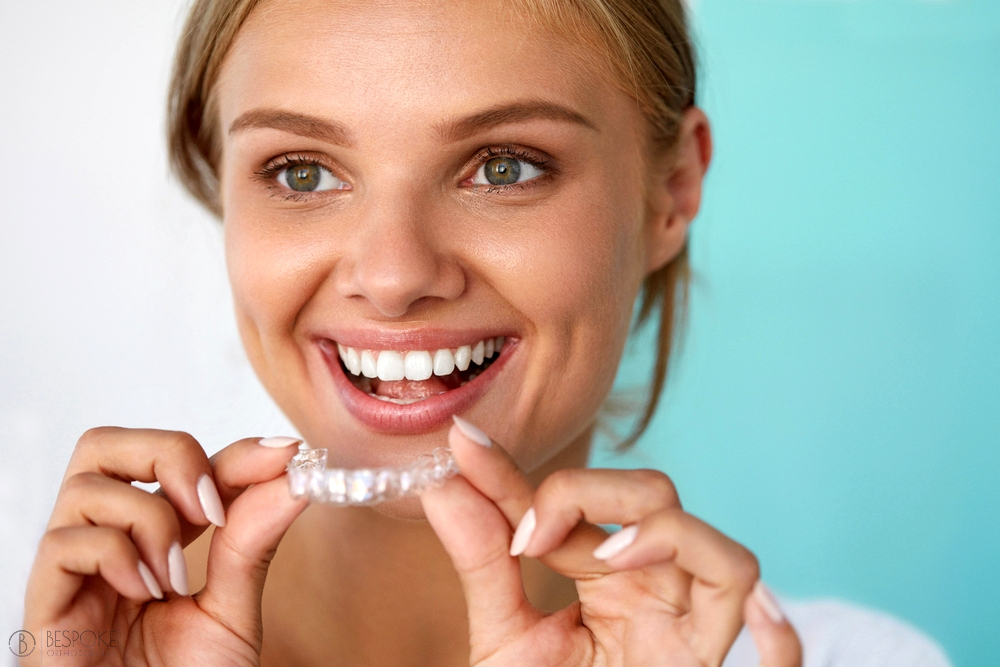 smiling woman with beautiful smile using invisalign clear aligners - How Does Invisalign Work in Burtonsville, MD